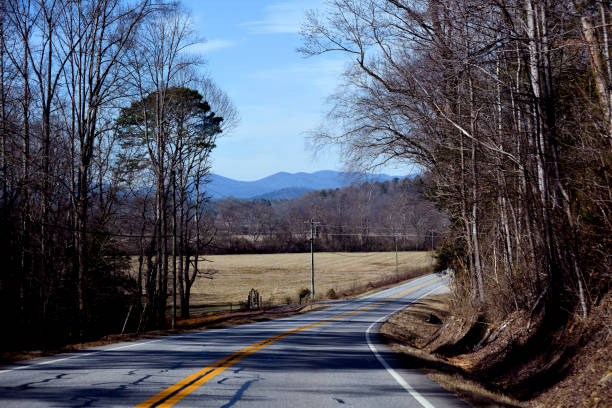 istock Scenic view driving on a country road 1465305749