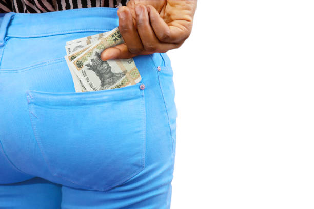 istock Black lady putting few Moldovan leu notes into her back pocket. Removing money from pocket, hold money 1465307131