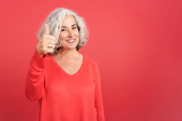 istock Mature woman gesturing agreement raising the thumb 1465309370