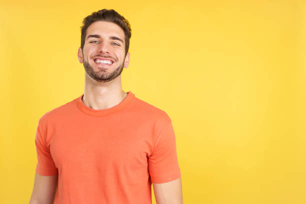 istock Handsome man standing with arms crossed laughing at the camera 1465309777