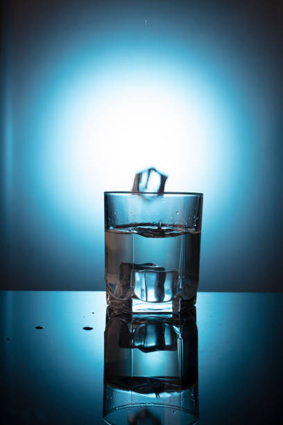 istock Vodka glass with ice on wooden table 1465311421