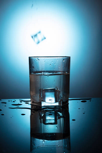 istock A glass with water at blue background 1465311423