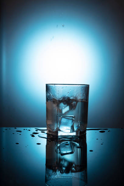 istock A glass with water at blue background 1465311429