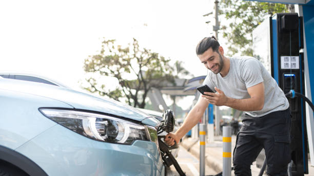 smiling caucasian man using ev charger