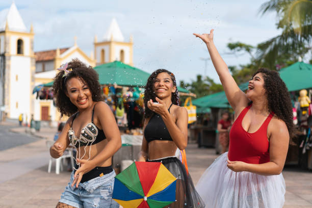 istock Women throwing confetti at Carnival in Olinda 1465314865