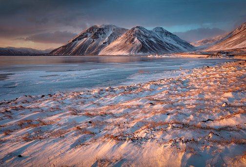 A frozen bay with mountain backdrop, eastern Iceland