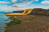 Unbelievable landscape - brown cliffs, highway, blue ocean. Amazing nature. Coulee Corridor National Scenic Byway, Eastern Washington