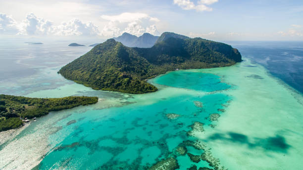 Aerial view of Bohey Dulang island panorama, beautiful blue lagoon and coral reef. Aerial view of Bohey Dulang island panorama, beautiful blue lagoon and coral reef. mabul island stock pictures, royalty-free photos & images