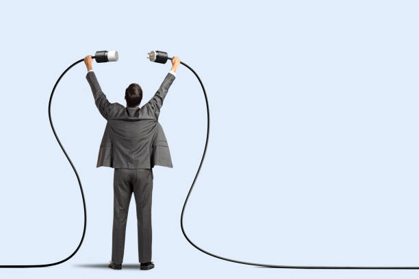 istock Man Plugging Two Power Cords Together 1465318386