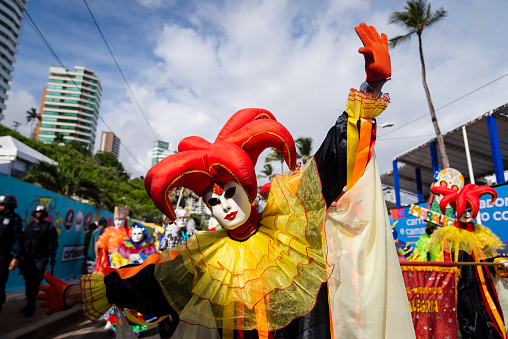 Salvador, Bahia, Brazil - February 11, 2023: People in venice carnival costumes are seen performing during the pre-carnival Fuzue parade in the city of Salvador, Bahia.