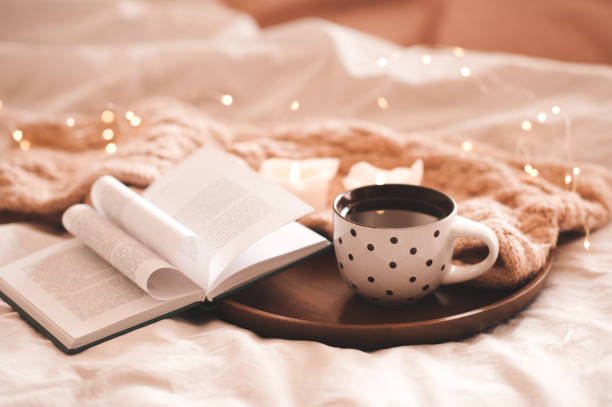 istock Mug of tea with paper book in bed 1465321920