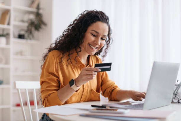 istock Arabic Lady Shopping Using Laptop And Credit Card At Workplace 1465326308