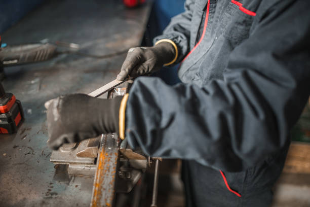 istock Close-up of hands of worker using metal rasp 1465326393