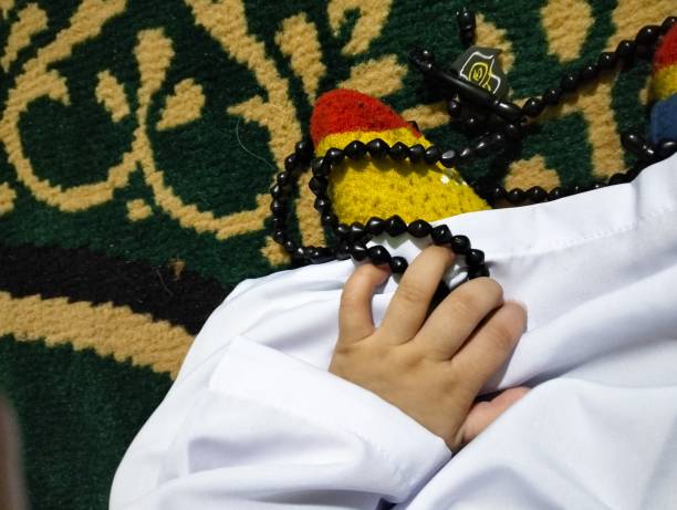 istock Hands Baby Holding a Prayer Beads 1465329358