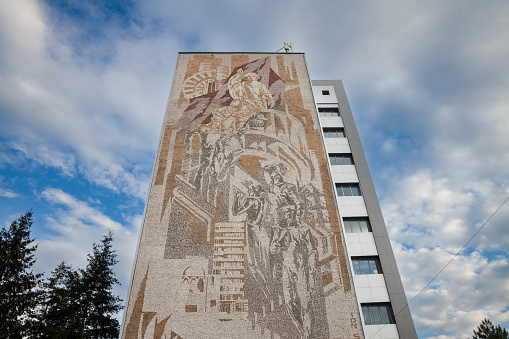 Picture of a communist fresco in Timisoara, Romania, on an old and decaying building, socialist architecture, designed in the 1960's, during the communist era of Romania.