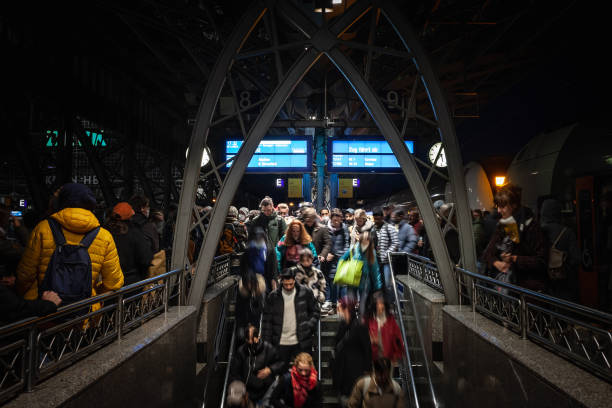 Picture of the Koln Hbf platform concourse with people rushing in a crowd in Cologne, Germany. Köln Hauptbahnhof or Cologne Central Station is a railway station in Cologne, Germany. The station is an important local, national and international transport hub, with many ICE, Thalys and Intercity trains calling there, as well as regional Regional-Express, RegionalBahn and local S-Bahn trains.