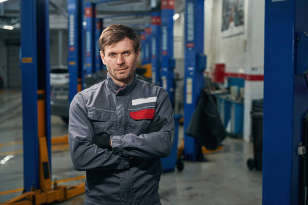 istock Man in overalls standing in the workshop 1465335736