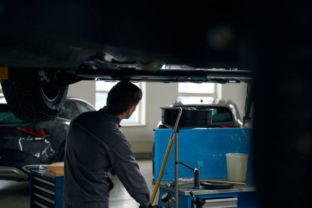 istock Male preparing car before repair, removing engine oil 1465335925
