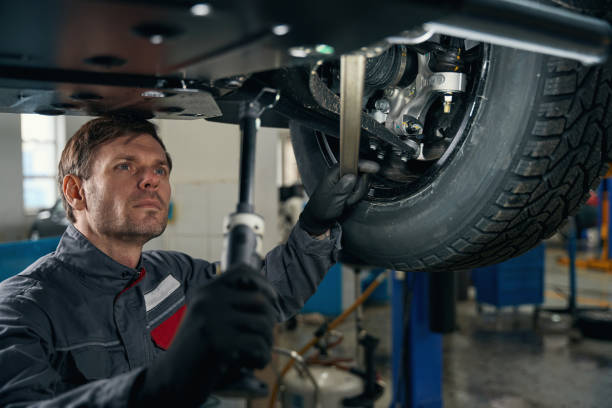 istock Worker inspecting car wheel in the workshop 1465336290