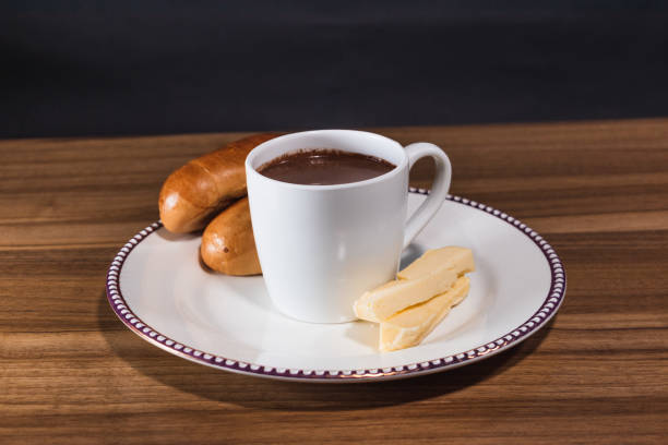 istock Hot chocolate drink with cheese and bread, Vertical image, wooden table, black background 1465337576