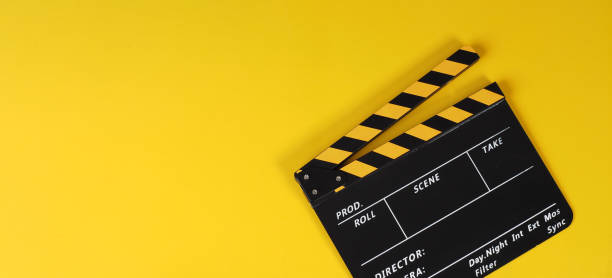 istock Clapper board or yellow movie slate on yellow background. 1465337580