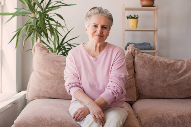 istock Smiling middle aged mature grey haired woman at home 1465337715