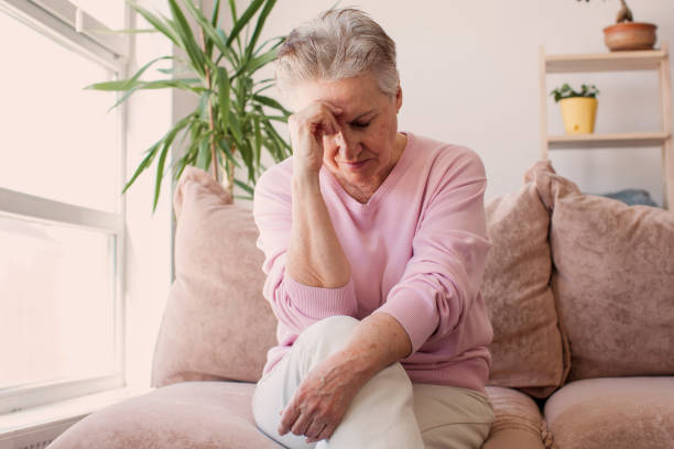 istock middle aged lady looking away sit alone at home feel anxious lonely, sad 1465337766