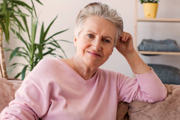 istock Smiling middle aged mature grey haired woman at home 1465337800
