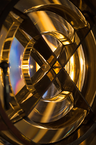 Close-up photo of a lighthouse lamp with glass rings of Fresnel lens in metal frame