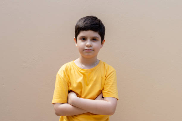 istock Boy with a serious expression and arms crossed 1465338874