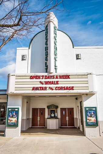 Greenbelt, MD, USA - January 18, 2023: The image is of the the Old Greenbelt Theatre, a one-screen movie theatre located in the heart of Old Greenbelt, Maryland, showing contemporary films in addition to offering a schedule of diverse and community based film programming, with new digital projection and 35mm reel-to-reel capabilities. The image is taken from the ground level  with no people in the photo.