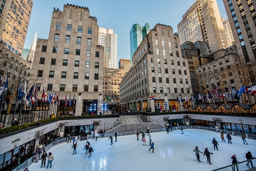 New York City, NY, USA - February 4, 2023: The image is of the the Rink at Rockefeller Center, the world's most famous ice skating rink and a can't-miss New York City experience, conveniently located steps from Times Square and the Theatre District. The image is taken from the ground level  with no identifiable people in the photo.