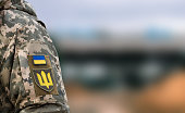 Ukrainian soldier. Flag, coat of arms trident on a military uniform. Armed Forces of Ukraine