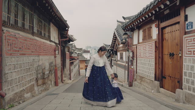 Mother and her daughter walking and playing together in Bukchon Hanok Village.