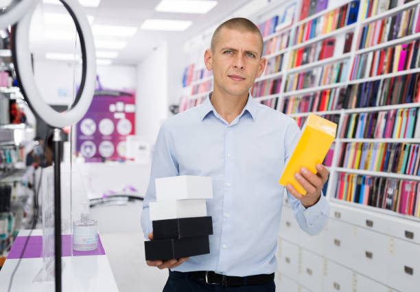 istock An electronics store seller demonstrates box with mobile phone 1465343623
