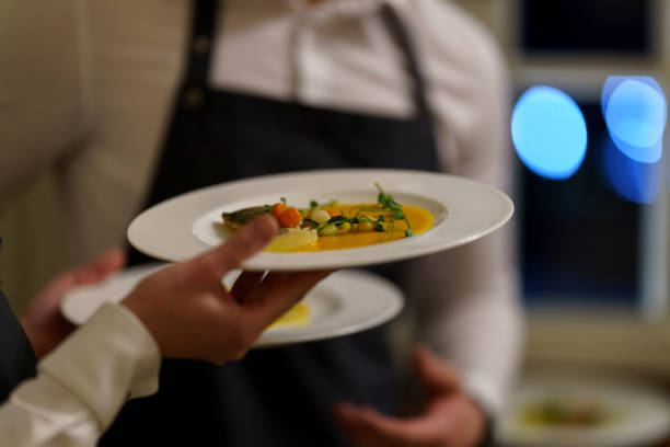 istock A waiter carrying a plate with an appetizer 1465344643