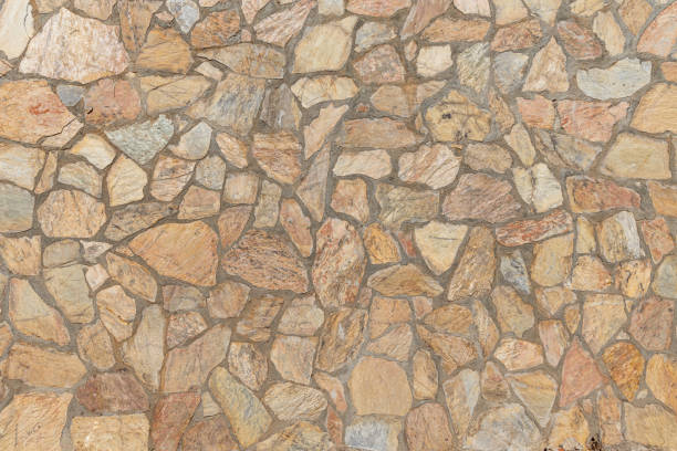 istock Beautiful texture of an old wall from orange stones with cracks 1465349911