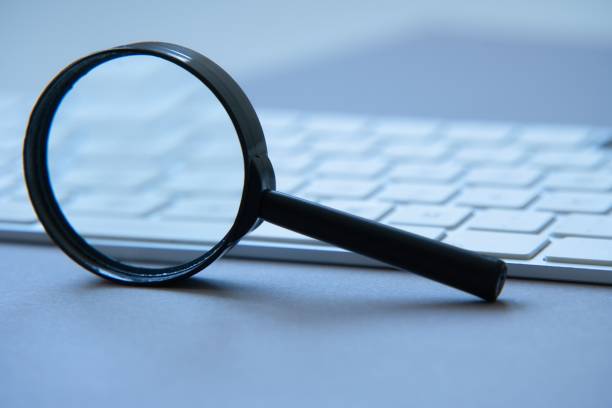 istock Magnifying glass and laptop keyboard. Seo. 1465351764
