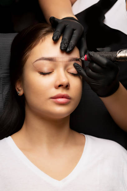 istock Beauty master applying permanent powder brow makeup 1465352363