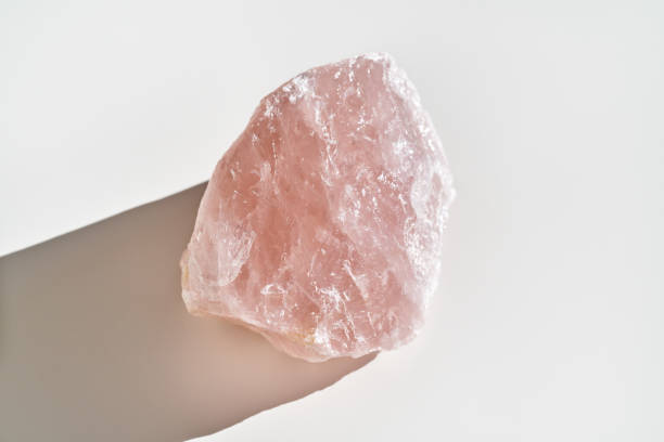 Rose quartz stone on white background stock photo