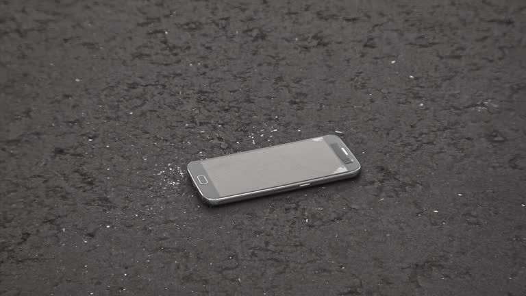 Smartphone Dropping on Asphalt in Slow Motion