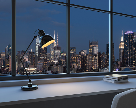 Home office interior with lamp on work desk with books, panoramic window on New York skyscrapers at night. Mockup product display. 3D rendering