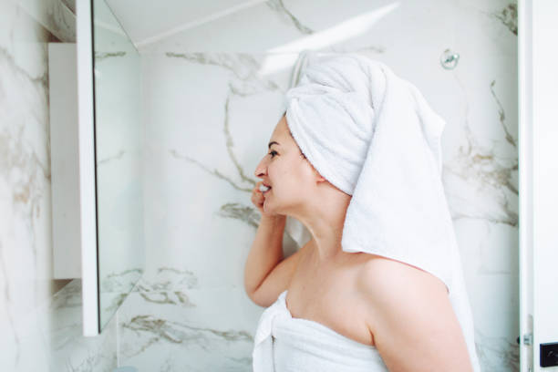 istock Mature woman in bathroom brushing her teeth 1465358994
