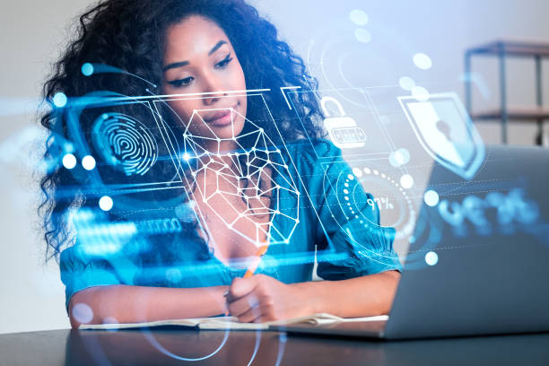 istock Black woman take note and looking at laptop, face recognition hologram 1465359497