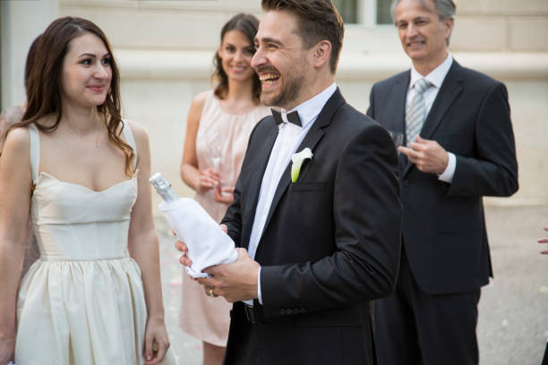 istock Groom opening champagne on his wedding 1465364504