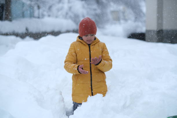 istock Little girl having fun outside while it's snowing 1465364550