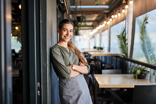 istock Arms crossed, pride and portrait of a waitress at a cafe for a welcome, service and happy at a restaurant. Diner, happiness and working woman at a coffee shop with confidence, vision and smile 1465364707