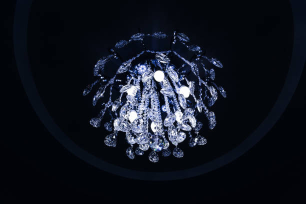 istock beautiful crystal chandelier with light bulbs on a dark ceiling 1465366004