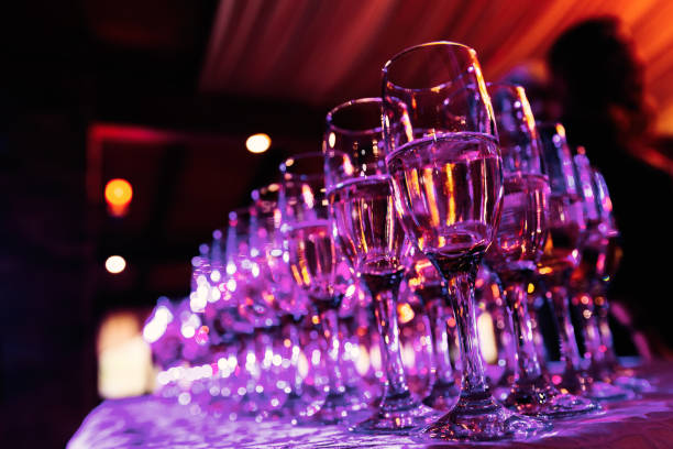istock transparent glasses with alcohol on a table with a tablecloth in a cozy restaurant and pink light shines on them 1465366116