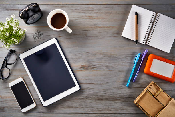 New year resolutions theme: Top view of Notepad, smartphone, digital tablet and sticky notes on a table with copy space